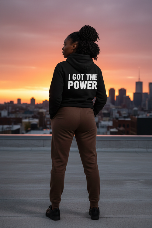 Black female model showing back with "I GOT THE POWER" text and sweatpants